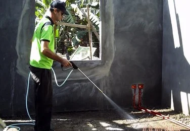 TERMITE PREVENTION & ELIMINATION Technician Spraying Termite Soil Posioning